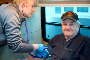 Student checking blood pressure in the Care Van.