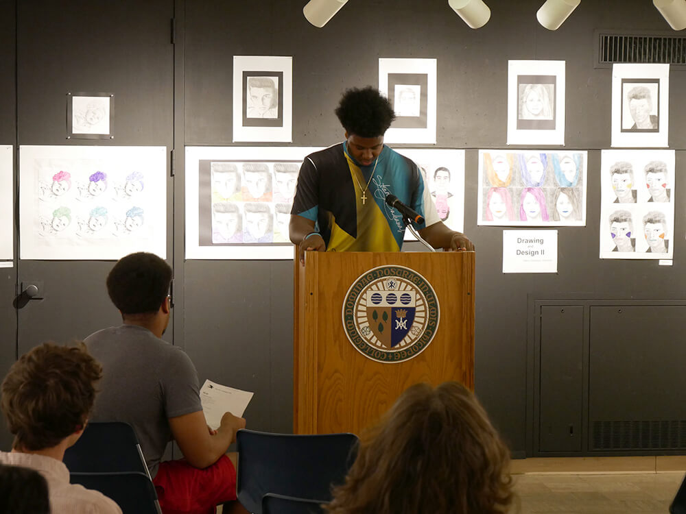 Photo of a student giving a reading at the Borgia Gallery