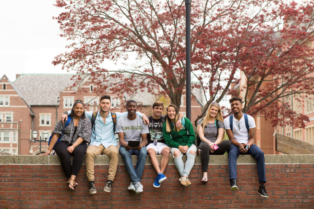 Photo of a group of students at the fire pit on the quad, Elms College