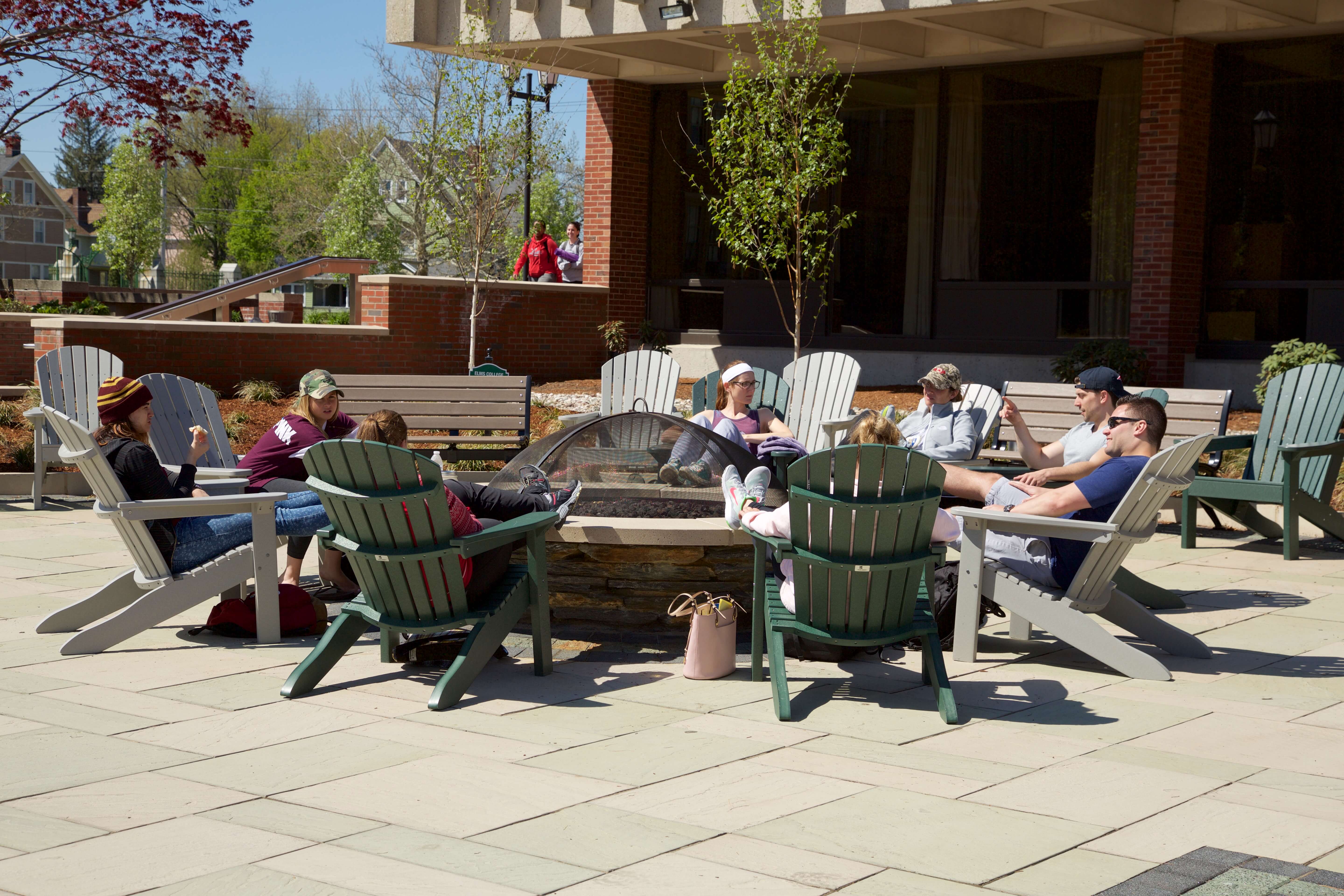 Photo of students at the firepit on the Keating Quad