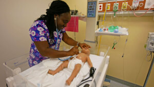 Photo of an RN-BSN student in a simulation lab at QCC