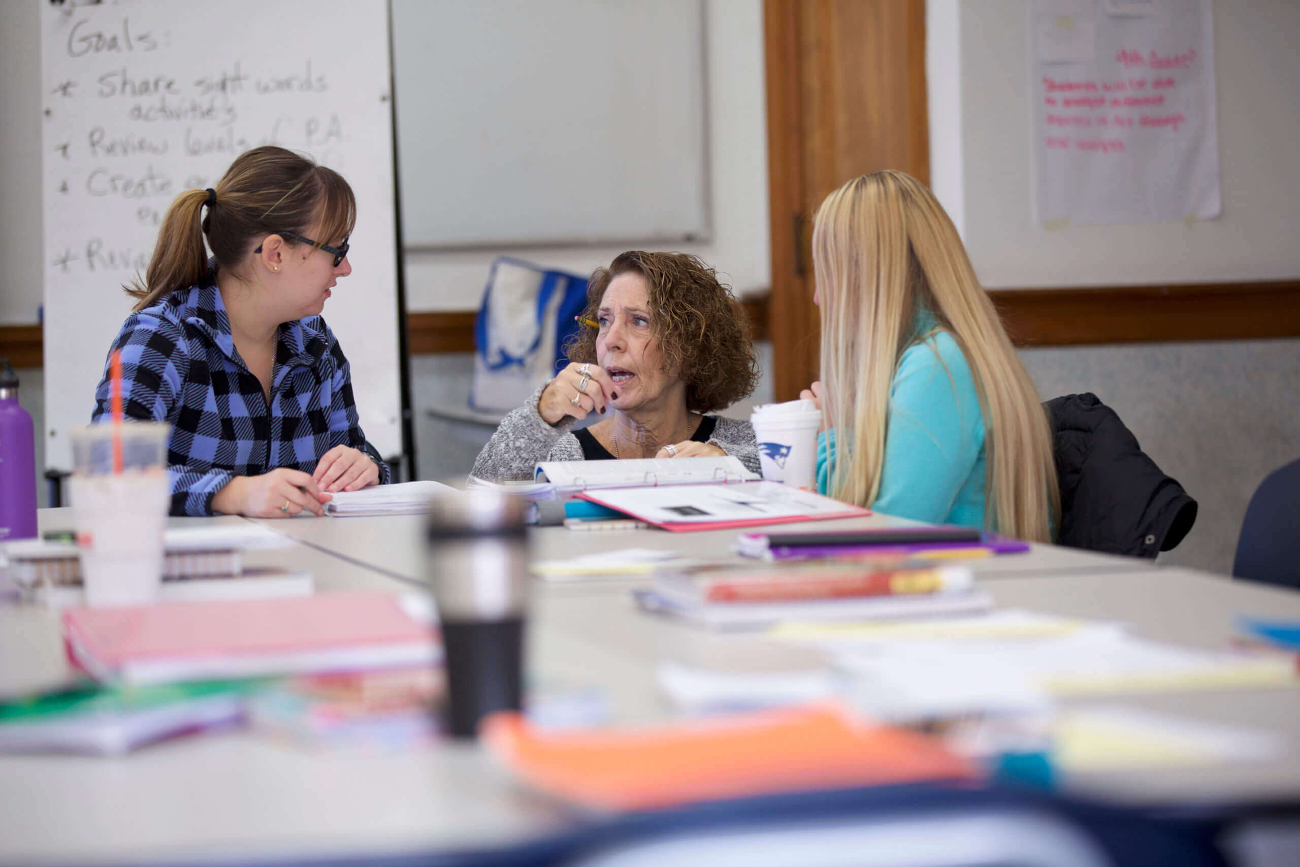 Photo of professor working with students in classroom
