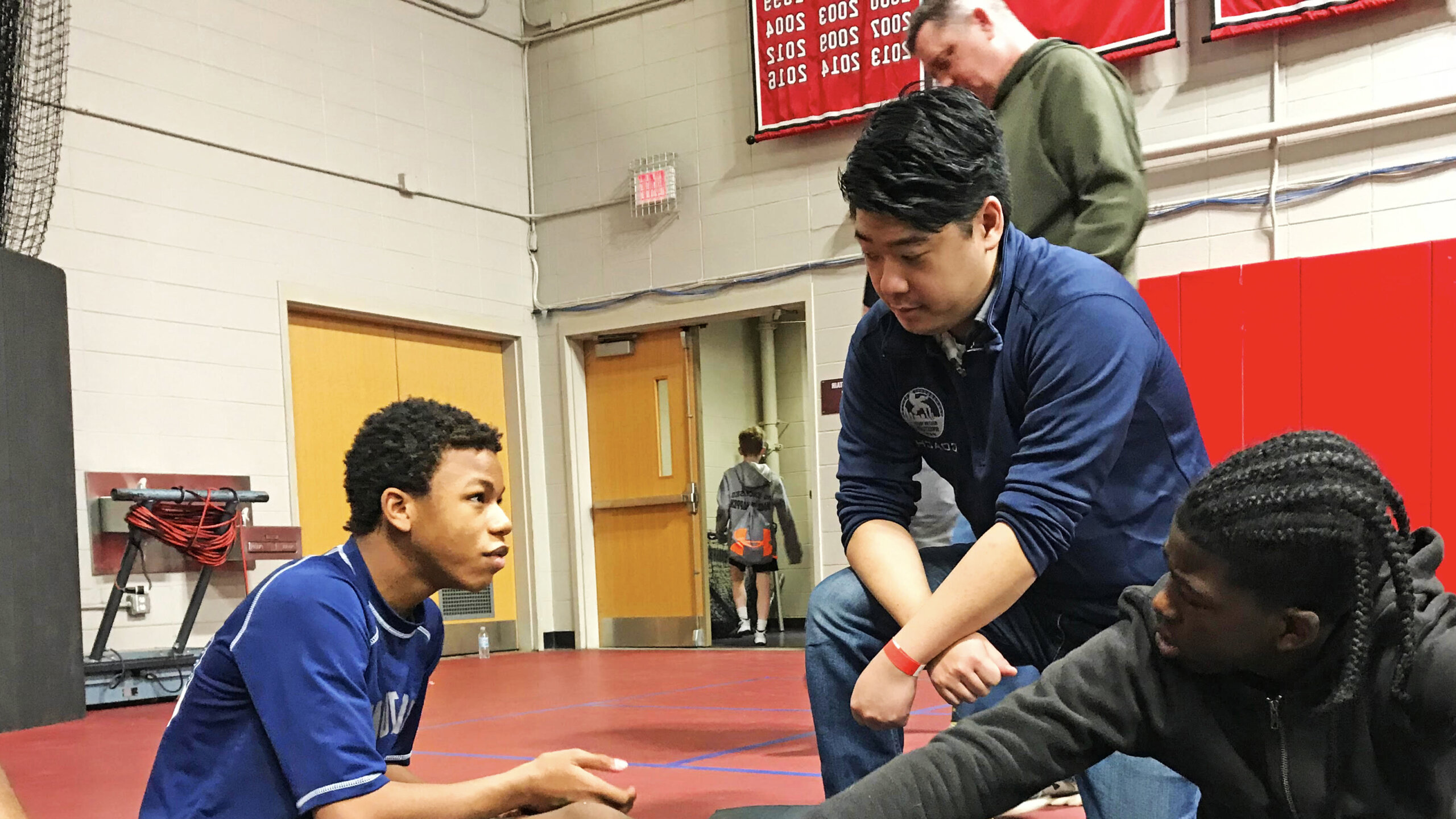 Photo of alumnus Addison Ray '15 at a youth wrestling event