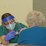 Photo of a nursing student at COVID-19 vaccine clinic