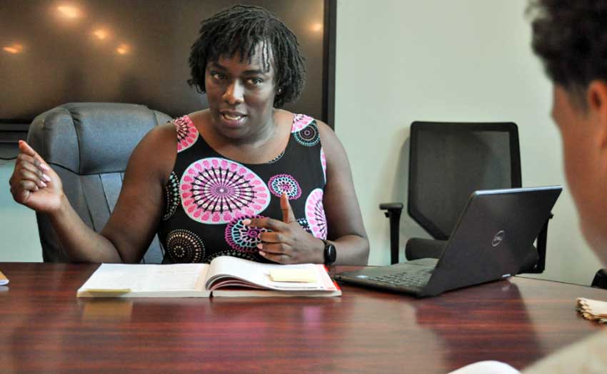 Bianca Bonsu, a summer school instructor with the Learn and Earn Literacy Corp, sitting at desk