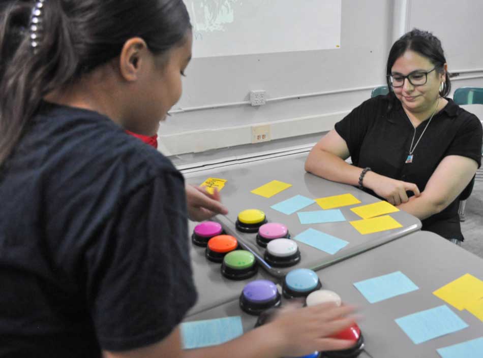 Alba Albo, an Elms student seeking her Education degree, two women at a desk