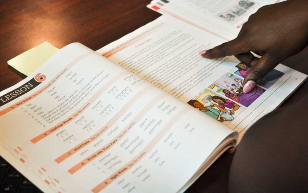 Woman reading, pointing at a book