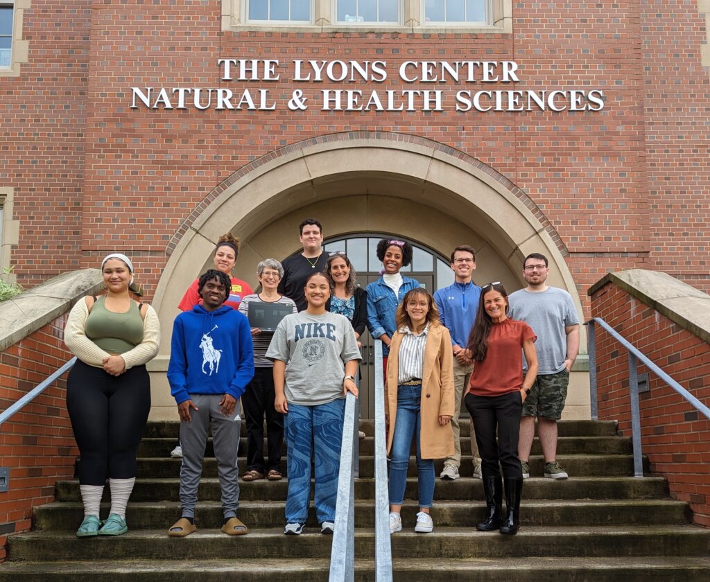 Photo of past S-STEM recipients: outside Lyon center at Elms College