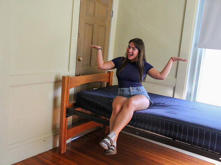 Woman student on dorm bed
