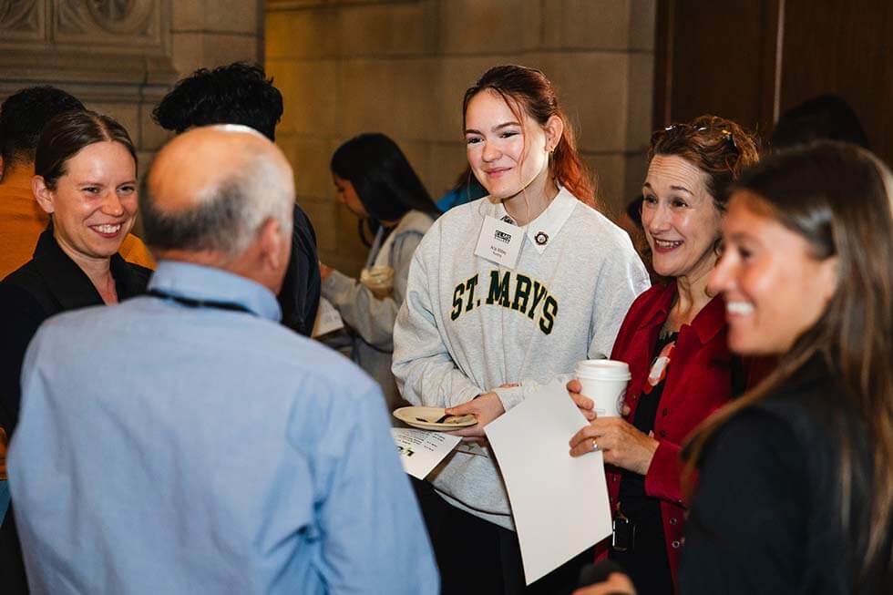 Photo of students meeting professor