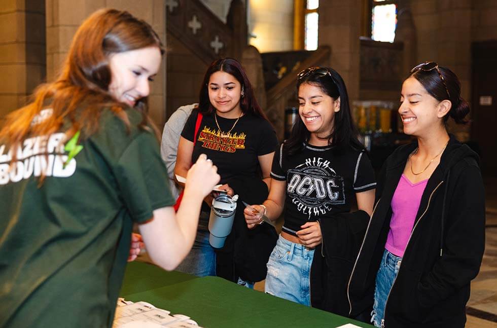 Photo of one woman and 3 female students 