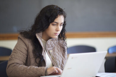 Photo of a female student on a laptop