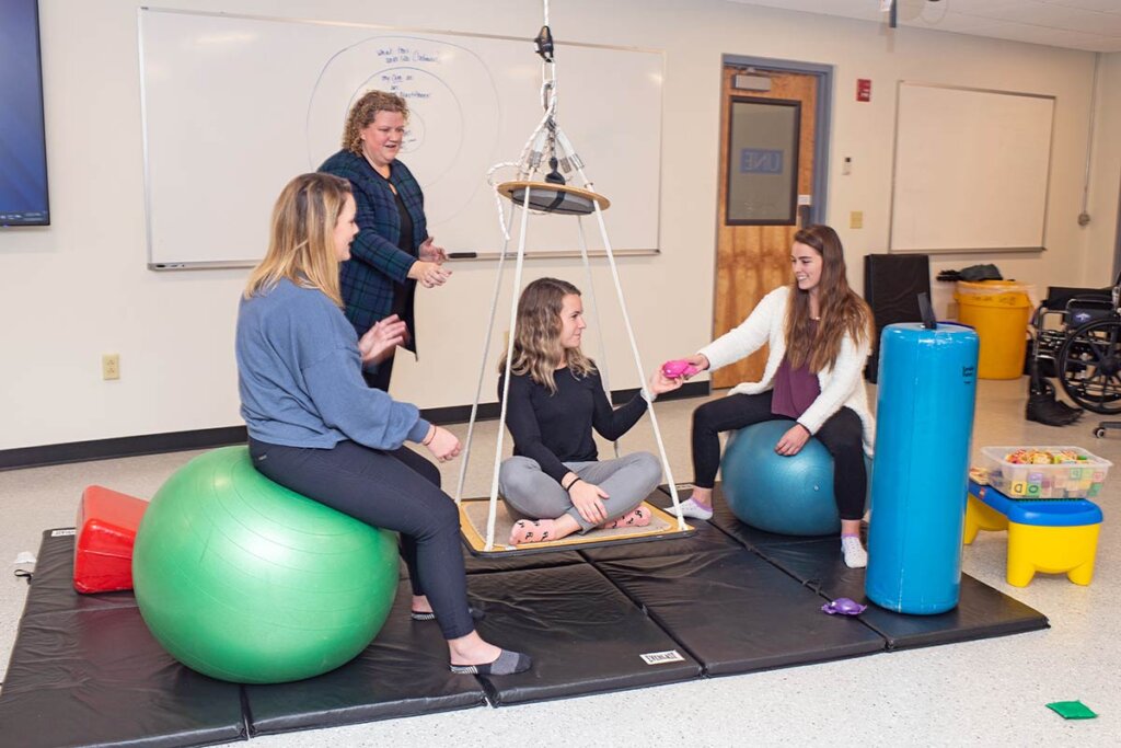 Photo of four women discussing physical therapy