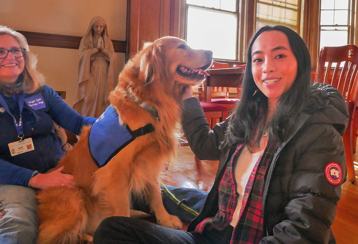 Photo of a Female student with a smiling dog 