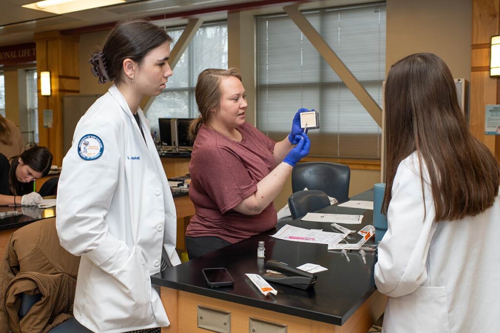 Photo of three women reviewing medication