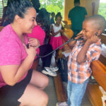 Photo of a woman and a child, Mission Trip to Jamaica, Elms College