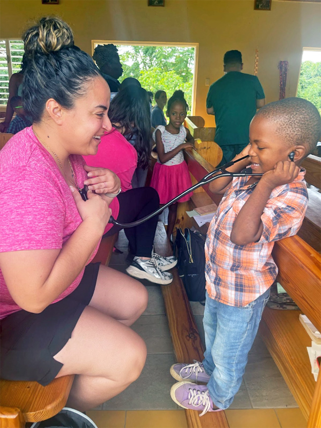 Photo of a woman and a child, Mission Trip to Jamaica, Elms College