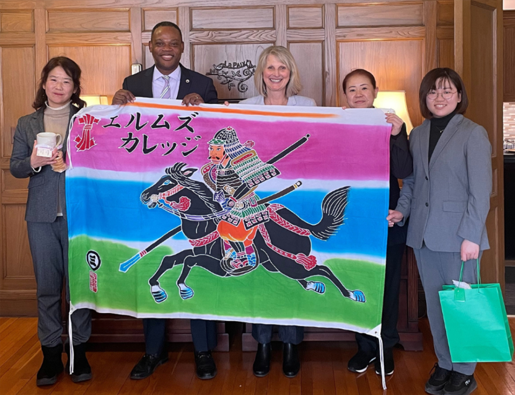 5 people holding a flag, from the University of Kochi in Japan