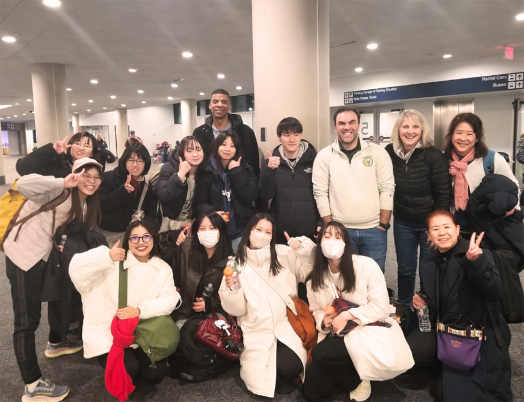 12 Students from the University of Kochi in Japan in an airport reception area with 3 Elms College staff