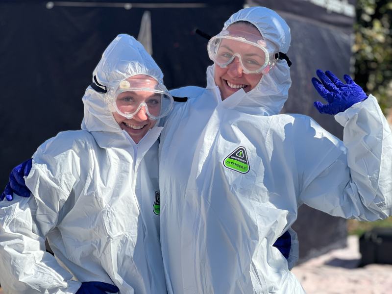 Two students in coveralls and goggles