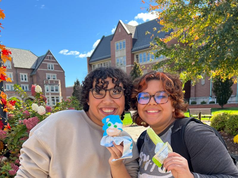 Two students outside with popsicles