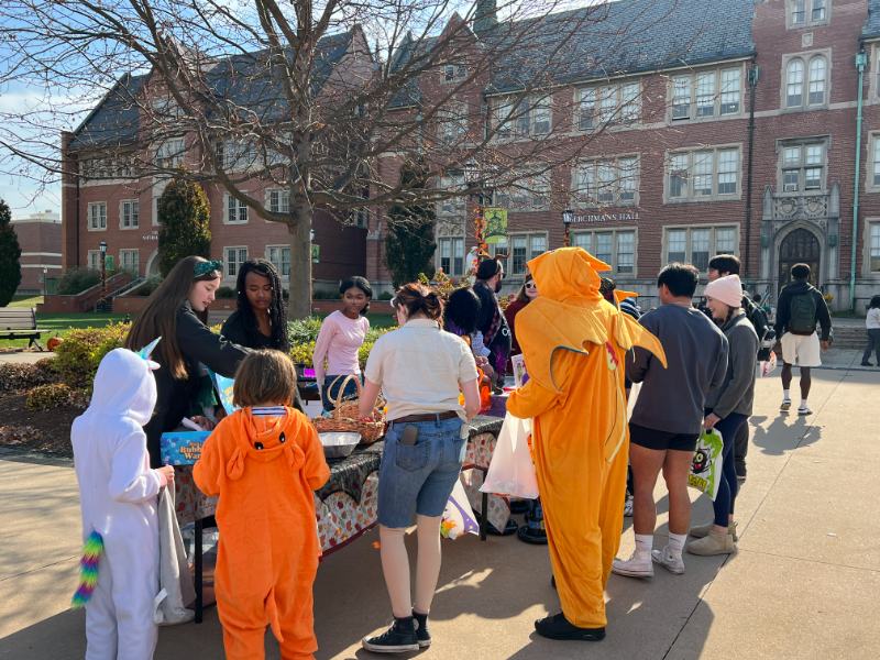 Photo of students and children during a Halloween event
