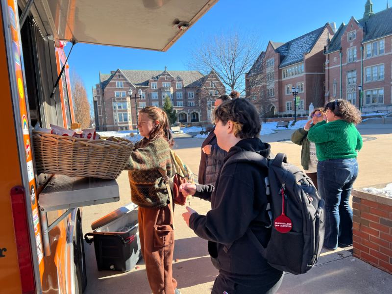 Photo of students receiving food from a food truck
