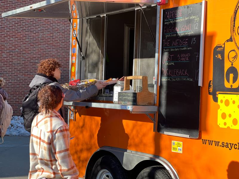 Photo of students receiving food from a food truck