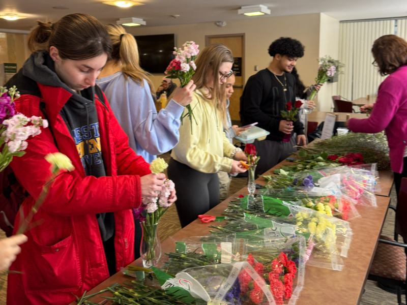 Photo of students at a table making custom bouquets