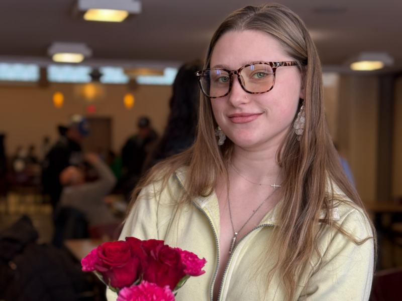 Photo of a student holding flowers