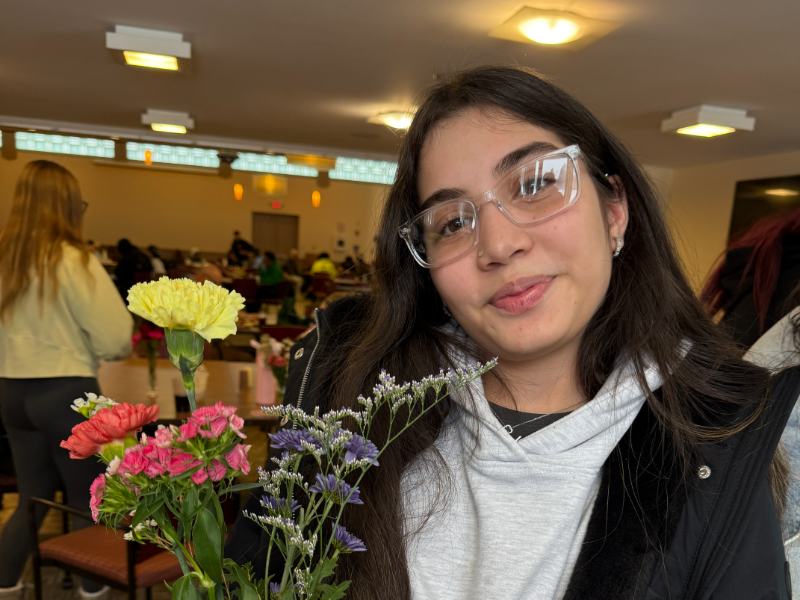 Photo of a student holding flowers