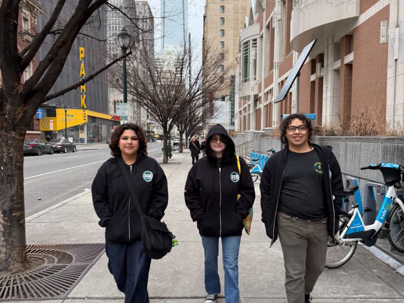 Photo of three students walking down the street