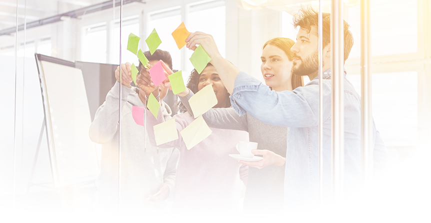 Group of people with sticky notes on a glass wall
