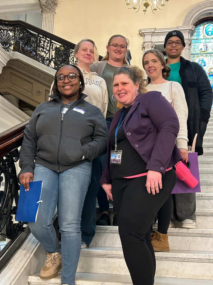 Photo of students and staff in a building