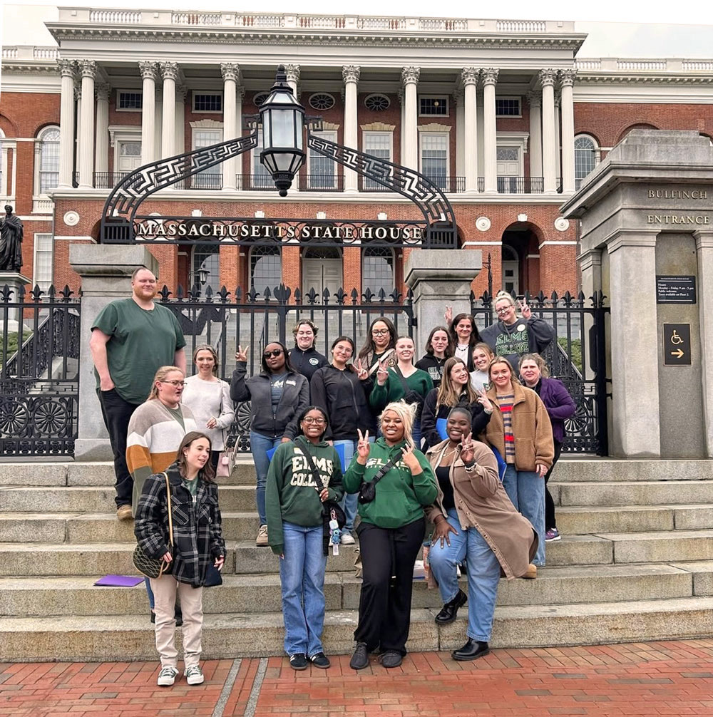 Photo of many students and staff standing outside a building
