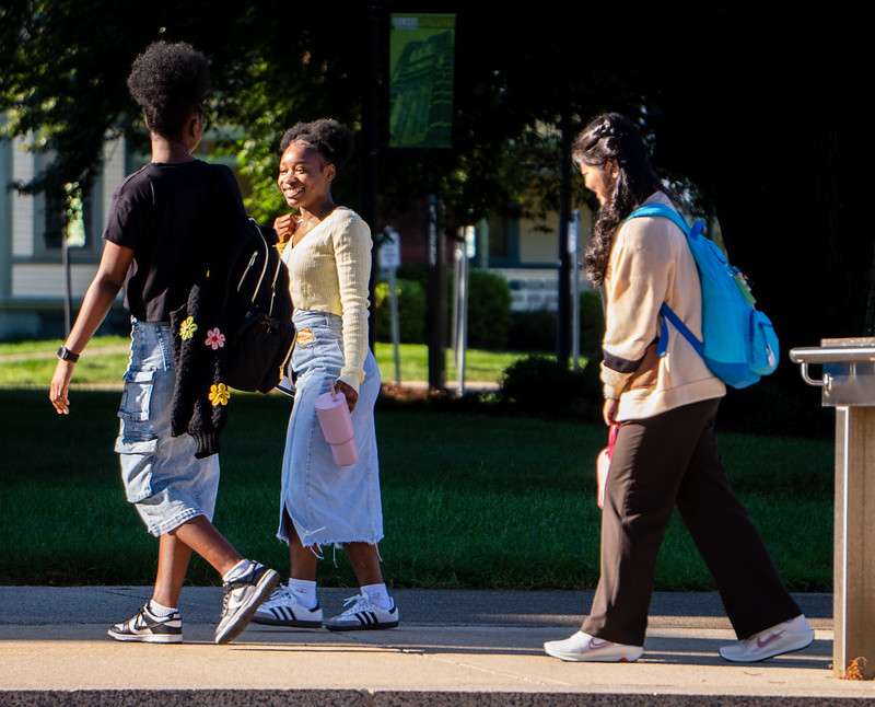 3 students walking around campus
