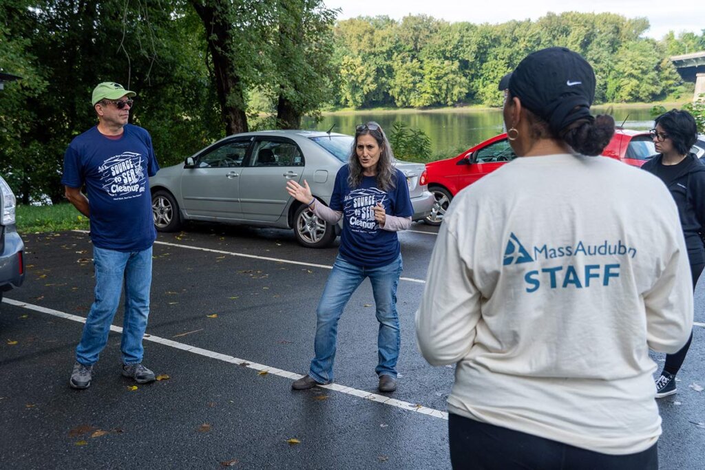 Biology professor Dr. Nina Theis, co-chair of the Elms’ Division of Natural Sciences, Mathematics and Technology speaks in a parking lot to students.
