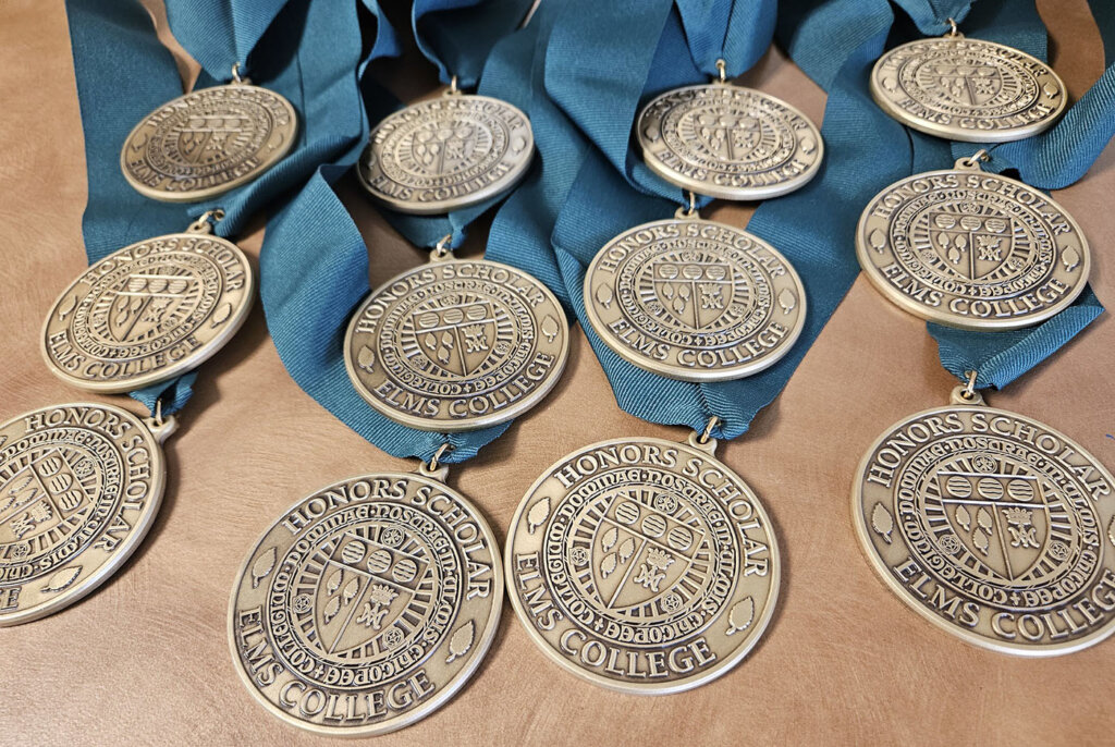 Honors Scholars 2024 award metals on a table