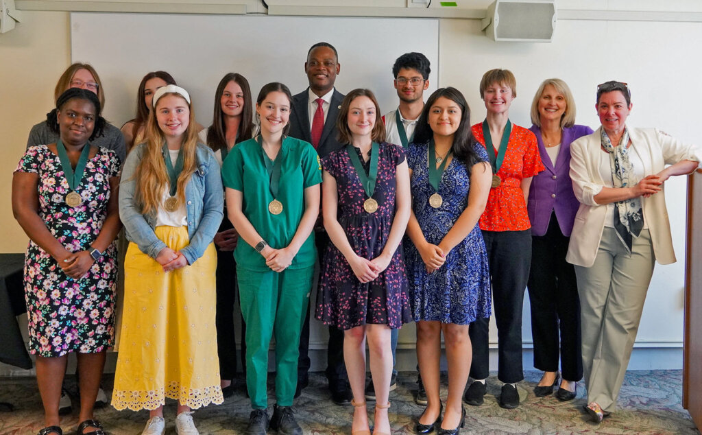 Honor Scholars celebration group photo. Juniors in the program were presented with a pin, while seniors were given a medallion that they may wear outside their gowns for the upcoming commencement.