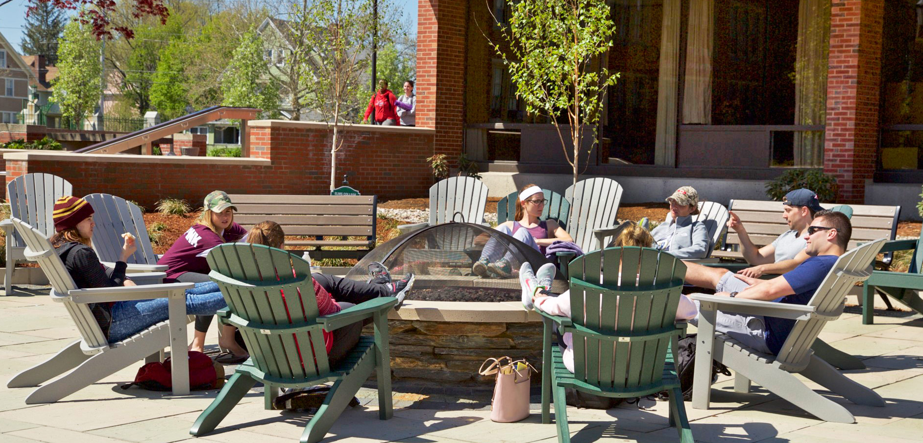Photo of students sitting around the fire pit