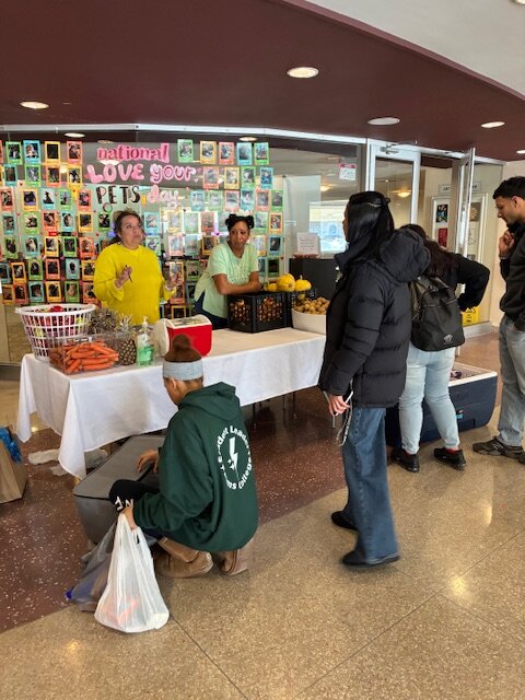 photo of free food in the commons building, several people